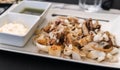 Grilled squid, grilled cuttlefish served as a Spanish tapa with garlic oil and Royalty Free Stock Photo