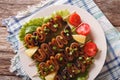 Grilled squid rings on skewers and vegetables close-up. horizontal top view Royalty Free Stock Photo