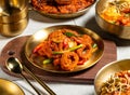 Grilled Squid Rings with spoon and chopsticks served in golden dish isolated on wooden board side view of honk kong food Royalty Free Stock Photo