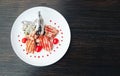 Grilled steak on a bone with tomatoes on a white plate. Hot Meat Dishes. top view Royalty Free Stock Photo