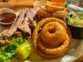 Grilled steak and chips dish with onion rings