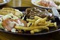 Grilled steak, French fries, Bread and vegetables Royalty Free Stock Photo