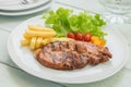 Grilled steak with french fries and vegetables on plate Royalty Free Stock Photo