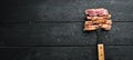 Grilled steak of pork on a fork, chopped with spices and herbs. Top view. Royalty Free Stock Photo