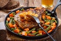 Grilled steak from pork with fried onions, green beans and carrots in a frying pan on a natural wooden background Royalty Free Stock Photo