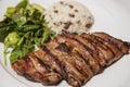 Grilled steak with rice and green leaf salad Royalty Free Stock Photo