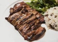 Grilled steak with rice and green leaf salad Royalty Free Stock Photo
