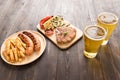 Grilled Steak with salad and beer and french fries, sausage on w