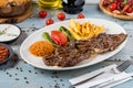 Grilled steak on wooden table. with bulgur pilaf, french frie