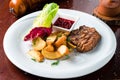 Grilled steaks, baked potatoes and vegetable salad Royalty Free Stock Photo