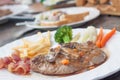 Grilled steaks, French fries, bacon and vegetable Royalty Free Stock Photo