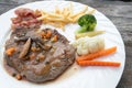 Grilled steaks, French fries, bacon and vegetable Royalty Free Stock Photo