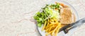 Grilled steaks and french fries with vegetables Royalty Free Stock Photo