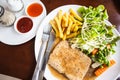 Grilled steaks, French fries with vegetables and seasoning Royalty Free Stock Photo