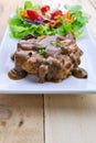 Grilled steaks, pork with pepper gravy and vegetable salad