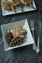 Grilled steaks from pork ribs with spices and herbs. Bone steak. Side view. Dark wooden background. Space for text Royalty Free Stock Photo