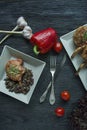 Grilled steaks from pork ribs with spices and herbs. Bone steak. View from above. Dark wooden background Royalty Free Stock Photo