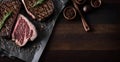 Grilled Steaks on Wooden Board with Rosemary and Spices, Copy Space Royalty Free Stock Photo