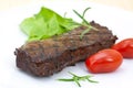 Grilled strip steak with tomato and salad