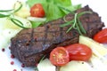 Grilled strip steak with tomato and salad