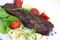 Grilled strip steak with tomato and salad