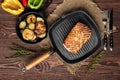 Grilled striploin on grill pan and fried eggplant on wooden background Royalty Free Stock Photo