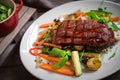 Grilled Juicy Striploin beef steak with vegetables on plate Royalty Free Stock Photo