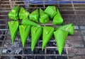 Grilled sweet sticky rice in banana leaf on charcoal stove Royalty Free Stock Photo