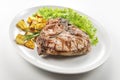 Grilled t-bone chop of pork with salad and potatoes Royalty Free Stock Photo