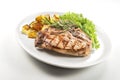 Grilled t-bone chop of pork with salad and potatoes Royalty Free Stock Photo