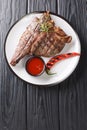 Grilled T-bone porterhouse are steak of beef cut from the short loin close up in the plate. Vertical top view