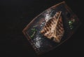 Grilled T-bone Steak on bones on wooden board Royalty Free Stock Photo