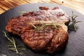 Grilled T-bone steak on stone cutting board