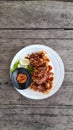 Grilled teriyaki chicken wings with cucumber slice dan chili sauce. Royalty Free Stock Photo