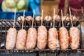 Grilled Thai sausage at street food market in Thailand, close up. Traditional Thai sausage with pork and rice, delicious street Royalty Free Stock Photo