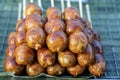 Grilled Thai sausage at street food market in Thailand, closeup. Traditional Thai sausage with pork and rice, delicious street Royalty Free Stock Photo