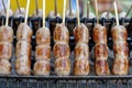 Grilled Thai sausage at street food market in Thailand, closeup. Traditional Thai sausage with pork and rice, delicious street Royalty Free Stock Photo