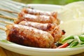 Grilled Thai sausage stuffed rice and pork eat with fresh vegetable on plate