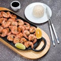 Grilled tiger shrimps with spices, lime and lemon, rice and soy sauce. Prawns fried with herbs. Grilled seafood served in chinese