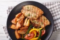 Grilled tilapia fillet, fried potatoes and a vegetable salad close-up. horizontal top view Royalty Free Stock Photo