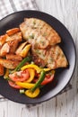 Grilled tilapia fillet, fried potatoes and a vegetable salad close-up. vertical top view Royalty Free Stock Photo