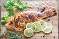 Grilled Tilapia with herbs on the wooden board