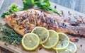 Grilled Tilapia with herbs on the wooden board