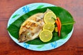 Grilled Tilapia with lemon and chili on banana leaves Royalty Free Stock Photo