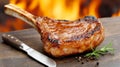 Grilled tomahawk steak on wooden board with herbs and flames Royalty Free Stock Photo