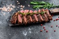 Grilled top blade, Denver steak. Marble meat beef. Black background. Top view