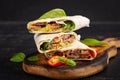 Grilled tortilla wraps with beef and fresh vegetables on wooden board. Royalty Free Stock Photo