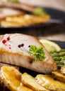 Grilled tuna steak served on asparagus with roasted potatoes Royalty Free Stock Photo