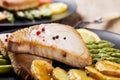 Grilled tuna steak served on asparagus with roasted potatoes Royalty Free Stock Photo