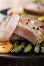 Grilled tuna steak served on asparagus with roasted potatoes Royalty Free Stock Photo